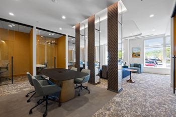 a meeting room with a table and chairs